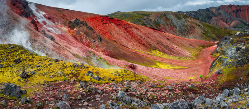 Landscape view of colorful rainbow volcanic Landmannalaugar mountains and famous Laugavegur hiking trail, with dramatic sky and snow in Iceland, summer
