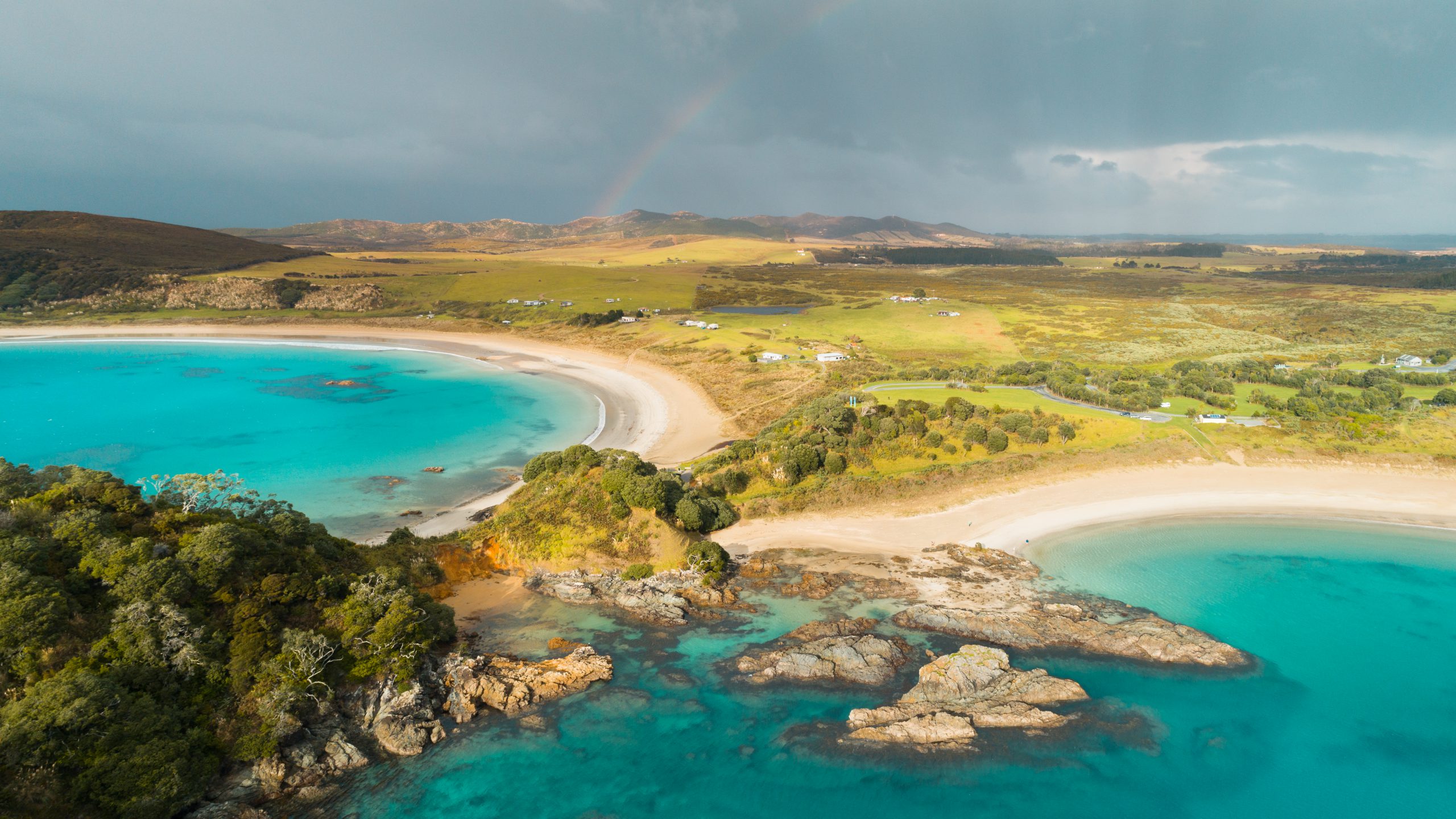 Panoramic view of clear water beaches in New Zealand. - Kipling & Clark