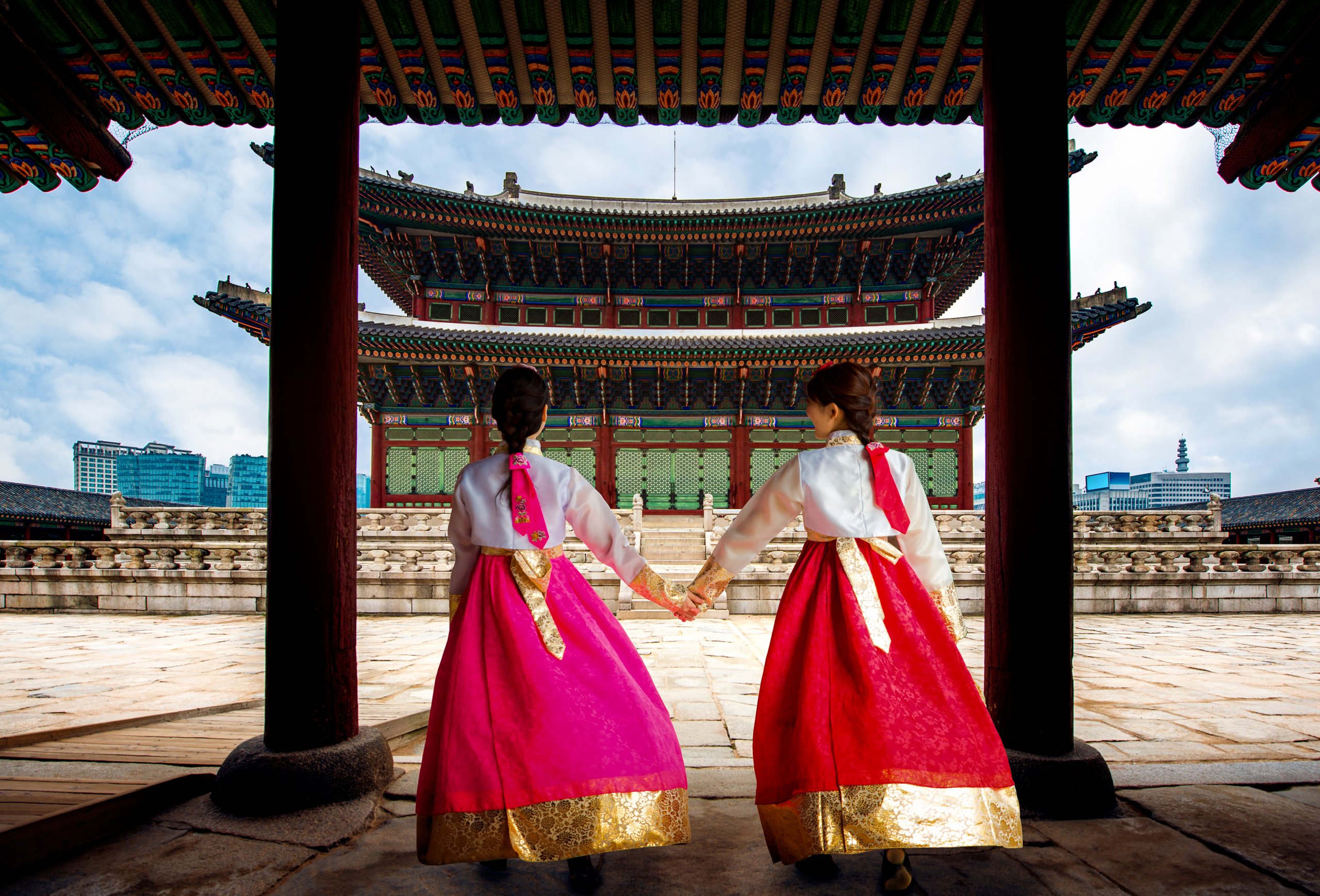 Korean lady in Hanbok or Korea gress and walk in an ancient town and Gyeongbokgung Palace in seoul